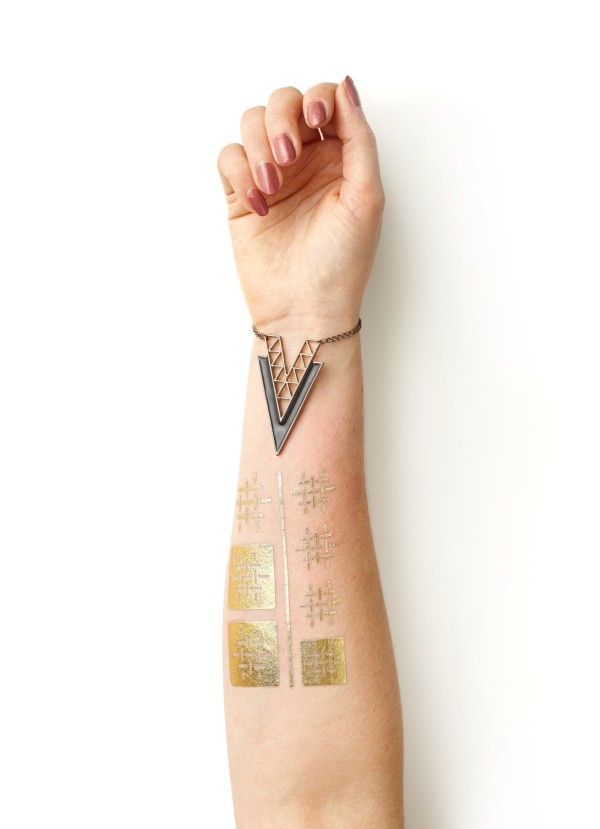 Close up of gold geometric custom metallic temporary tattoos on a forearm, ideal for showcasing premium metallic tattoo design sheets.
